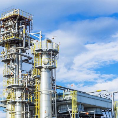 Two absorption columns stand at the gas processing plant . Two absorption columns stand at the gas processing plant against the blue sky.